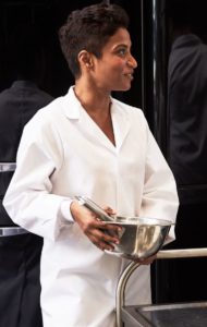 female employee wearing a white food coat