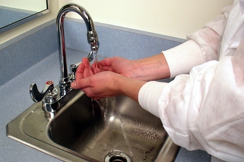 A person washing her hand