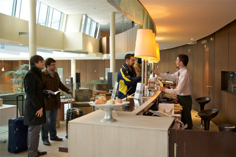 Hotel officer assisting visitors.