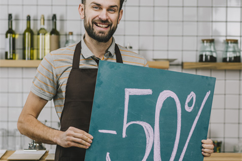 happy male employee holding a discount board