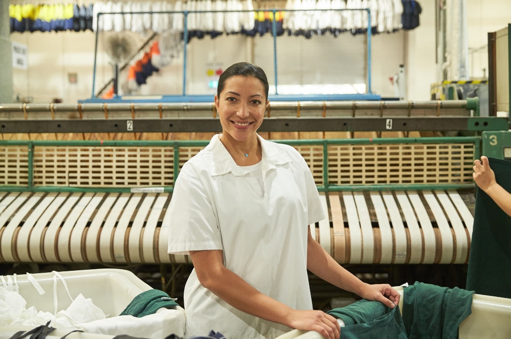 happy employee wearing a white uniform