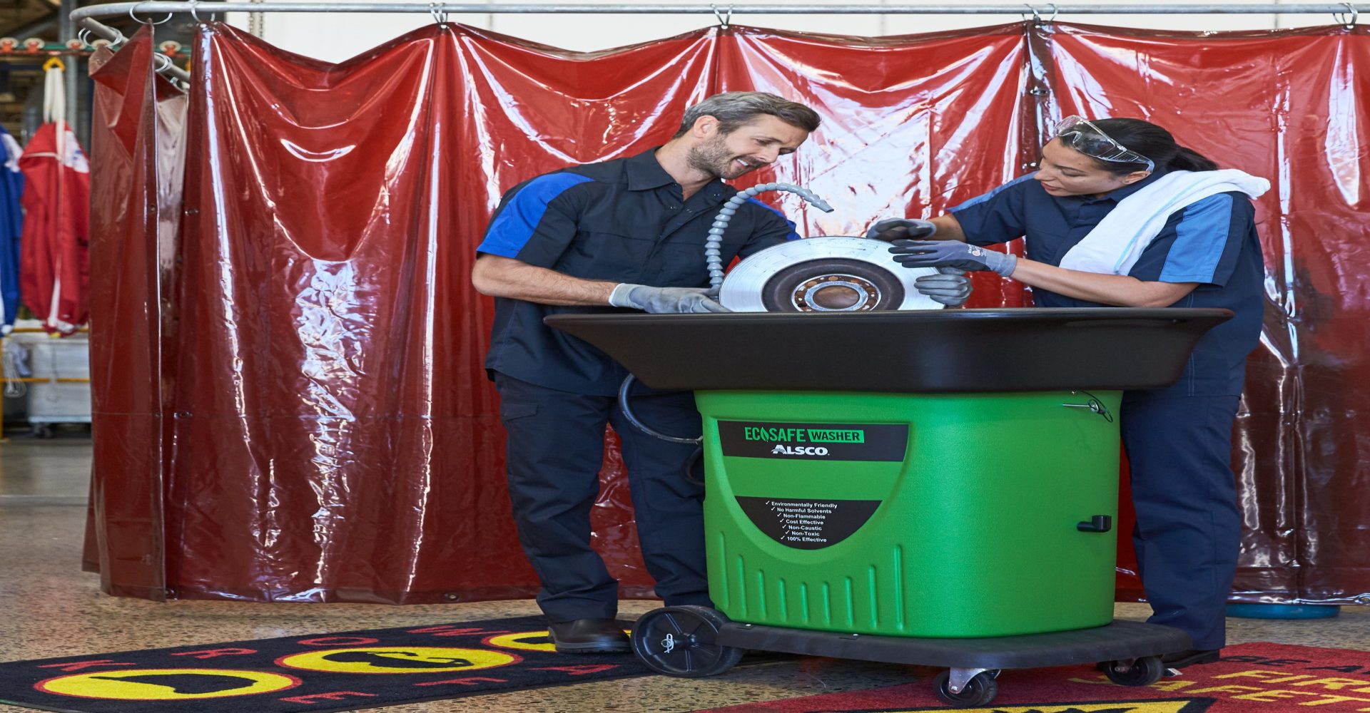 two employees use the Alsco parts washer